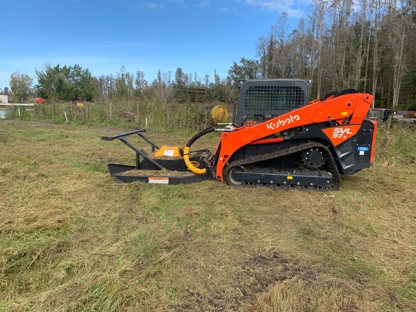 Professional equipment carrying large logs during land clearing